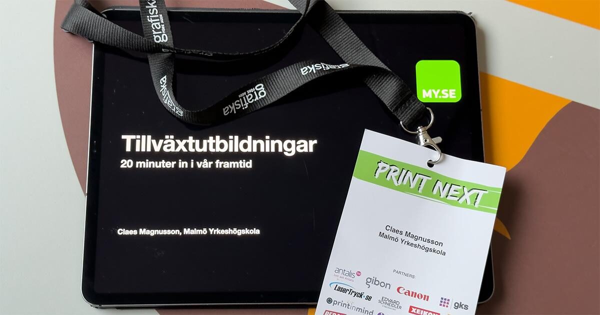 En surfplatta visar en presentation med titeln Tillväxtutbildningar bredvid en PRINT NEXT-evenemangsbricka med ett snöre, med namnet Claes Magnusson och olika sponsorlogotyper.